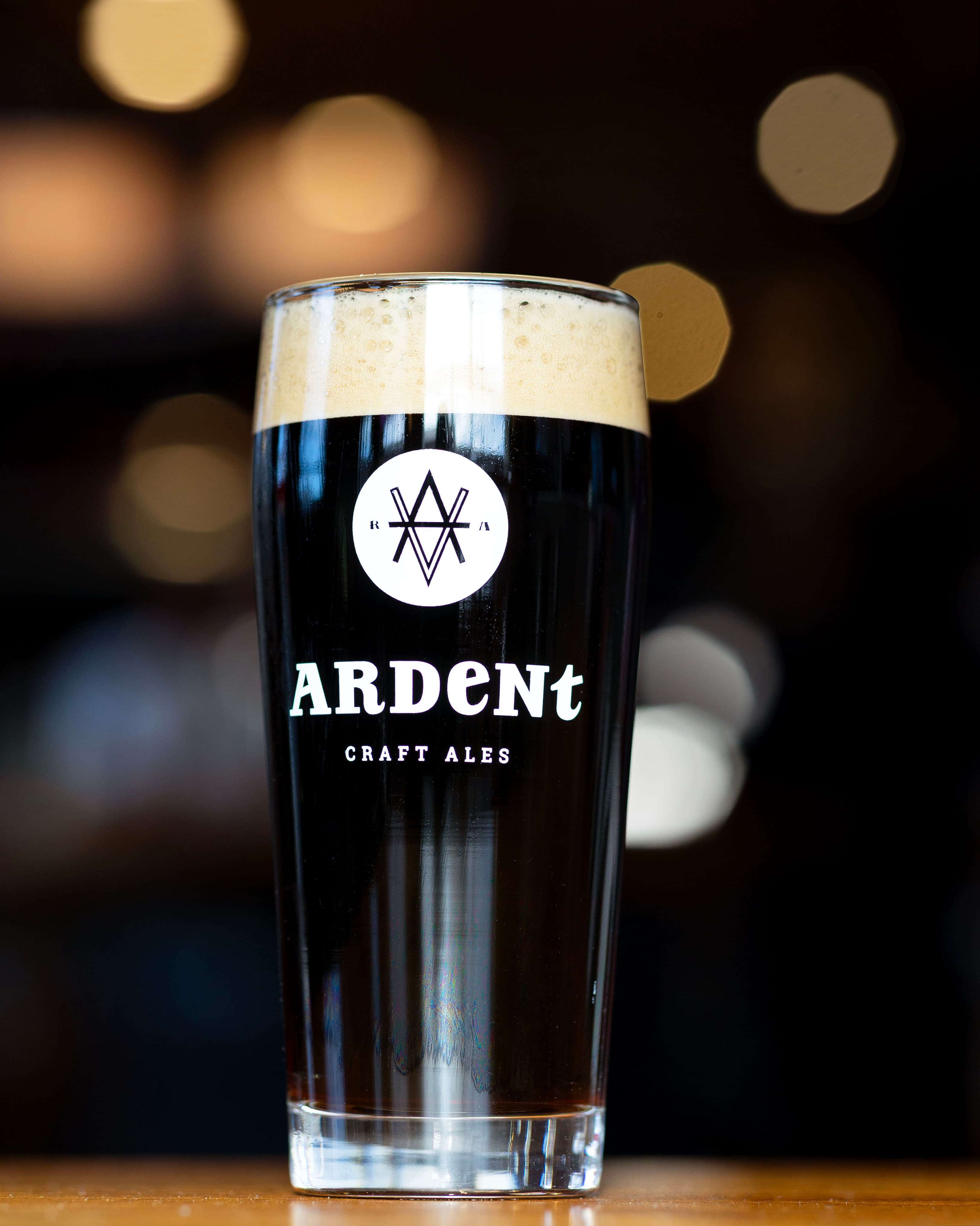 tall 16oz glass of dark beer