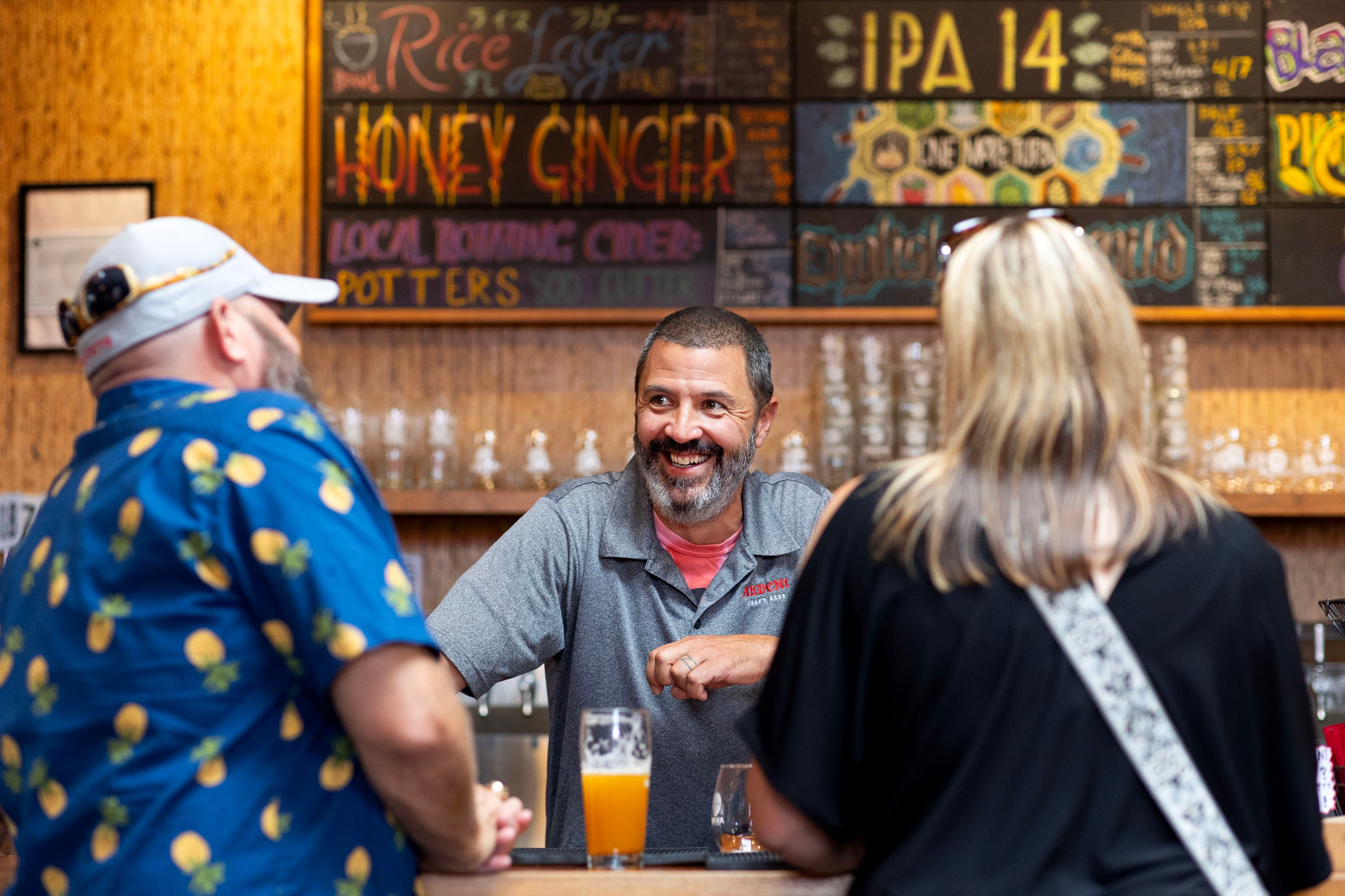 Server chatting with guests at the taproom bar