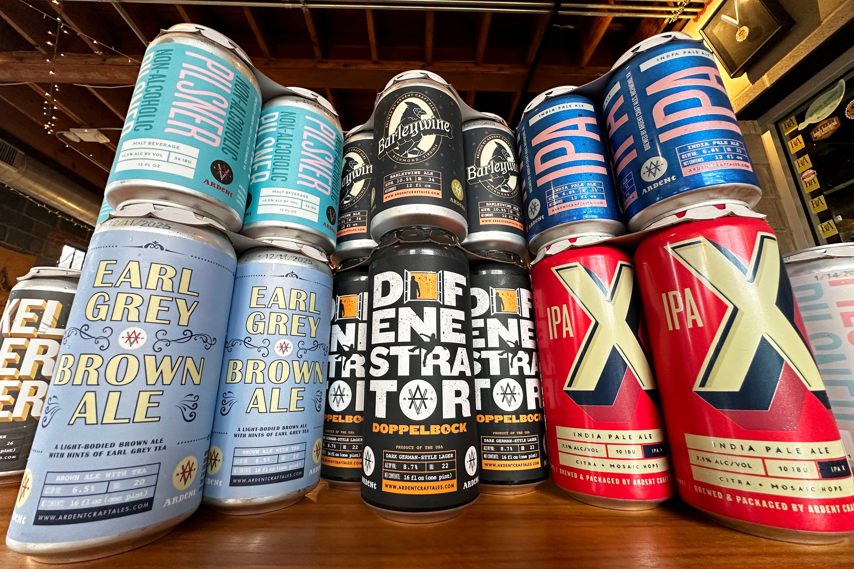 Various 4-packs and 6-packs of beer cans, many colors and styles