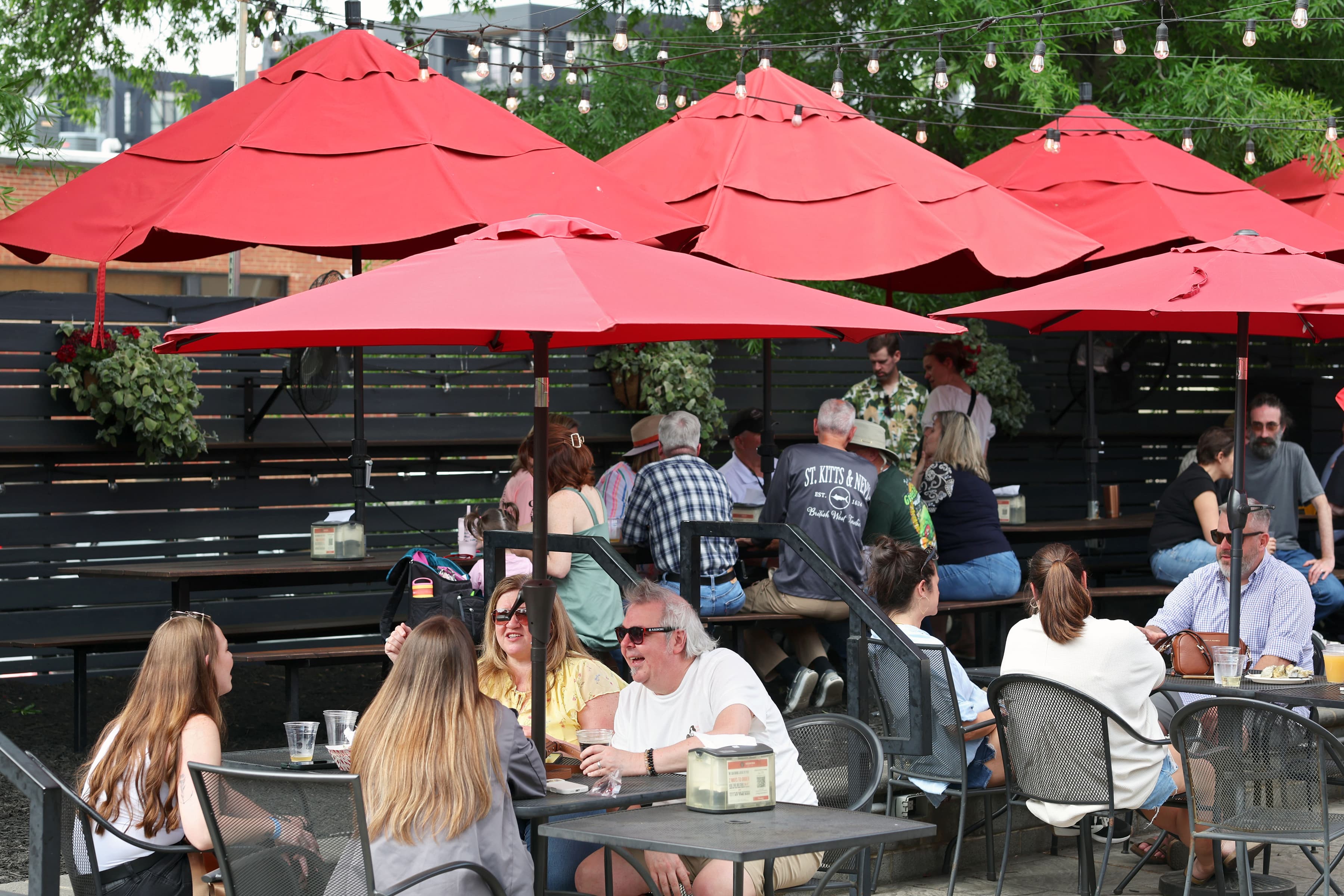Outdoor patio filled with guests on a sunny spring afternoon