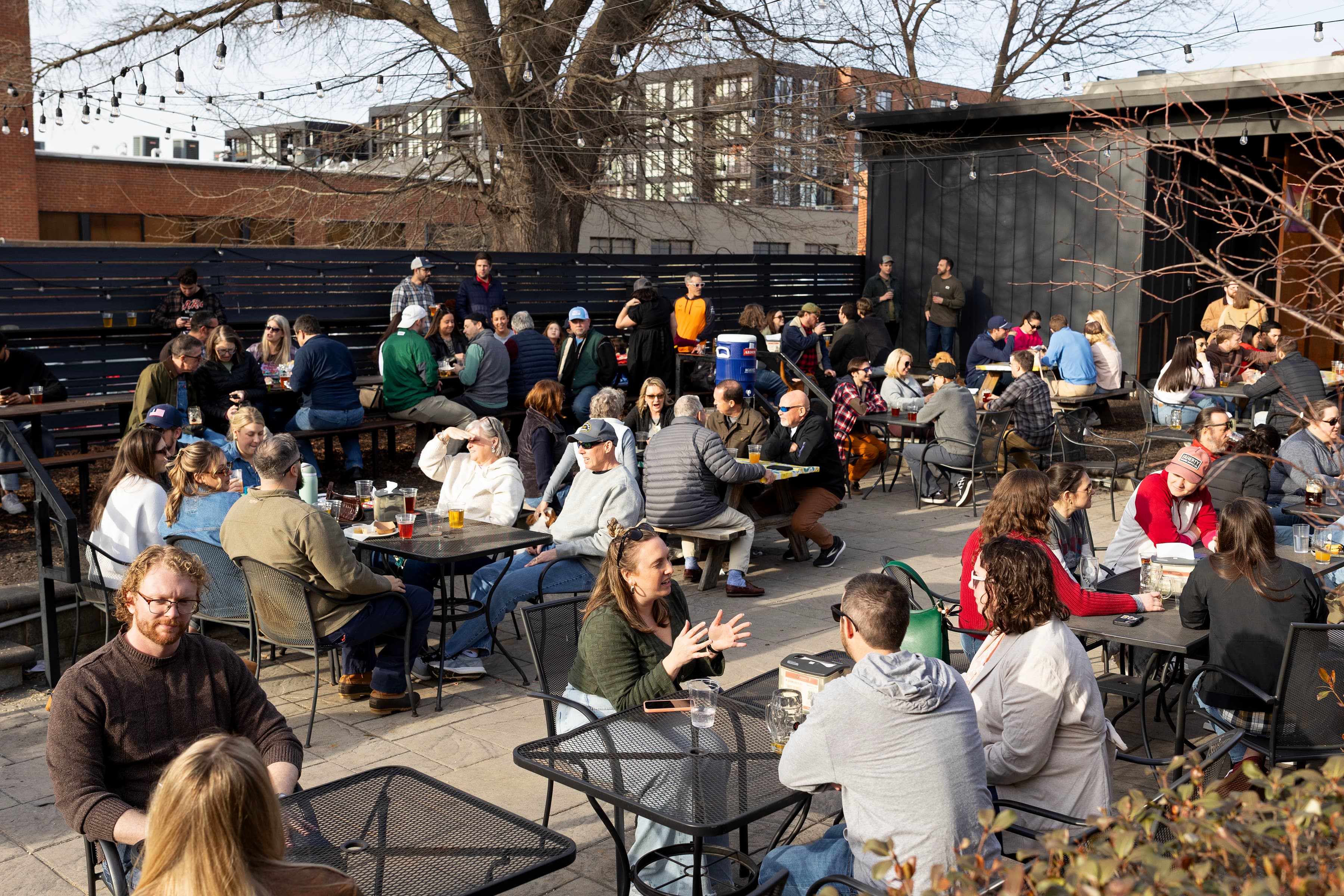 Outdoor patio filled with guests on a sunny spring afternoon