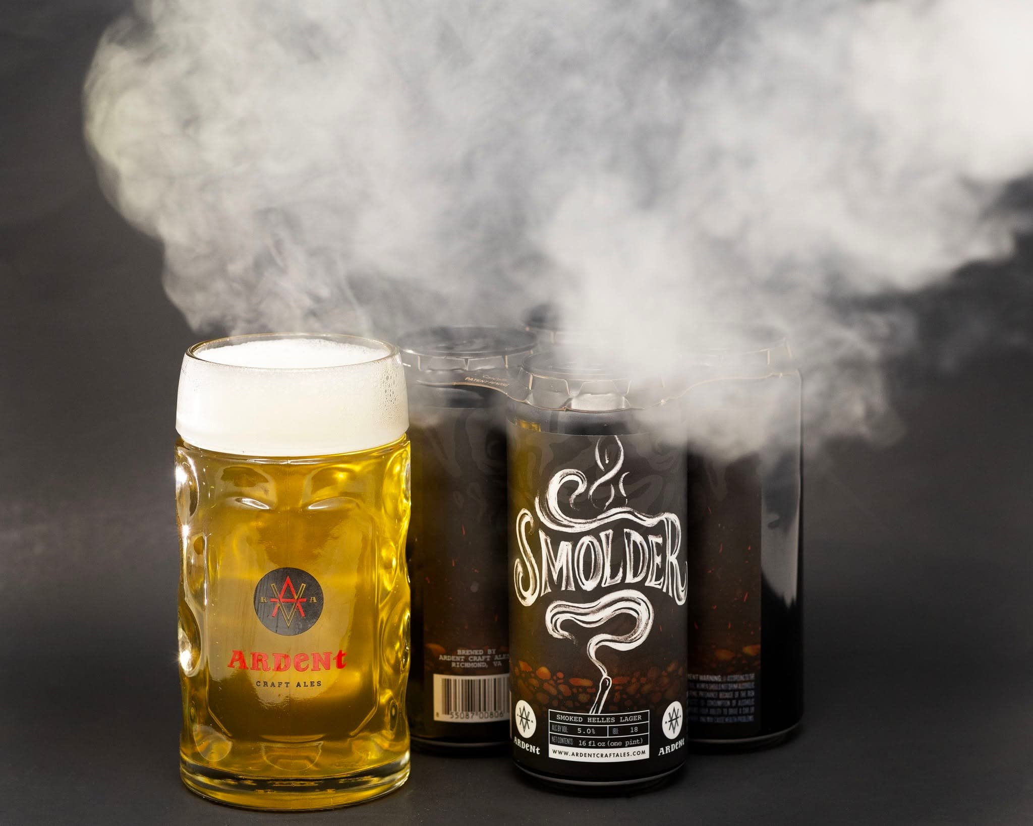 4-pack of black cans of Smolder next to a stein of Beer with smoke billowing out t