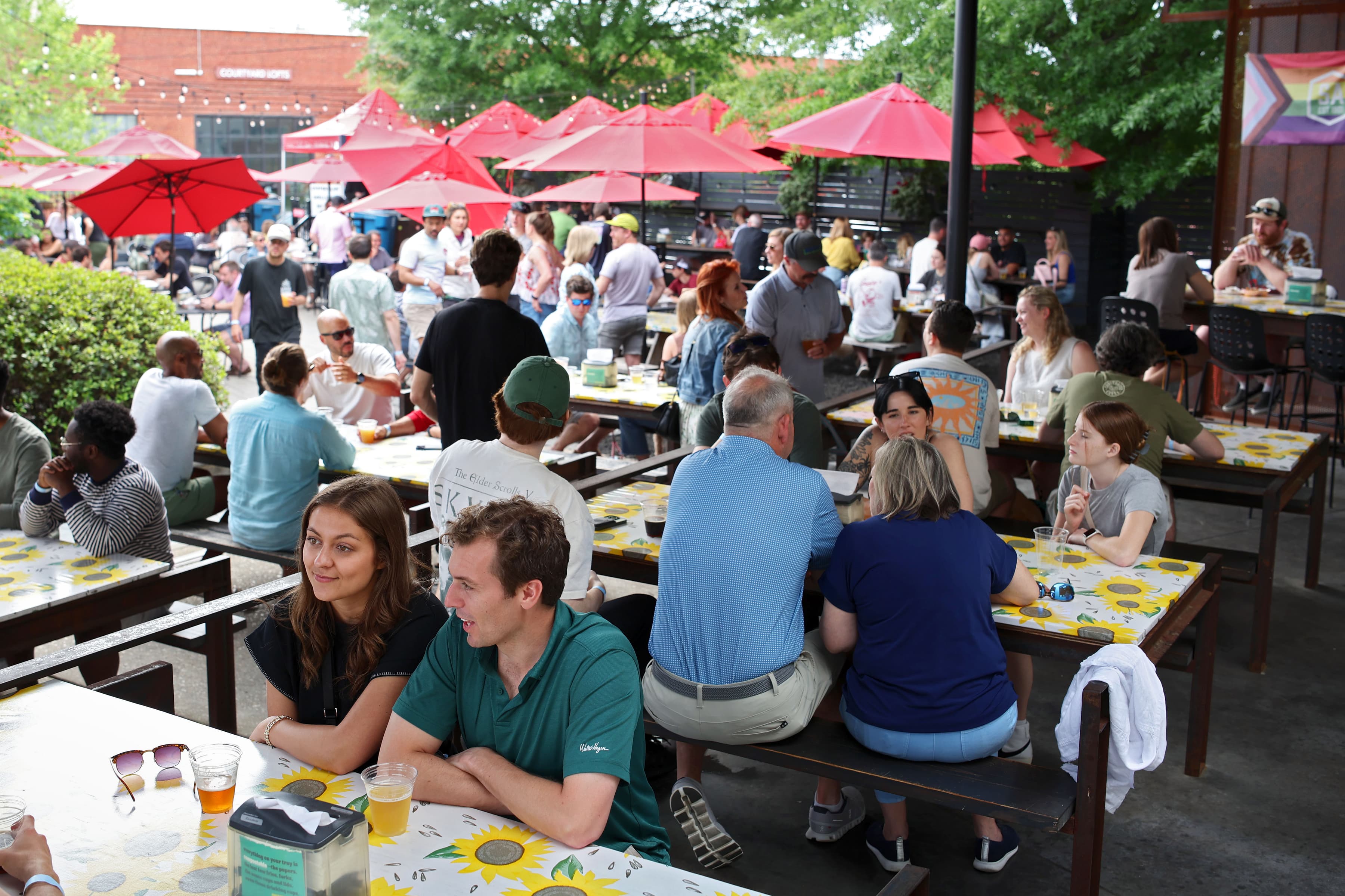 Outdoor patio filled with guests on a sunny spring afternoon