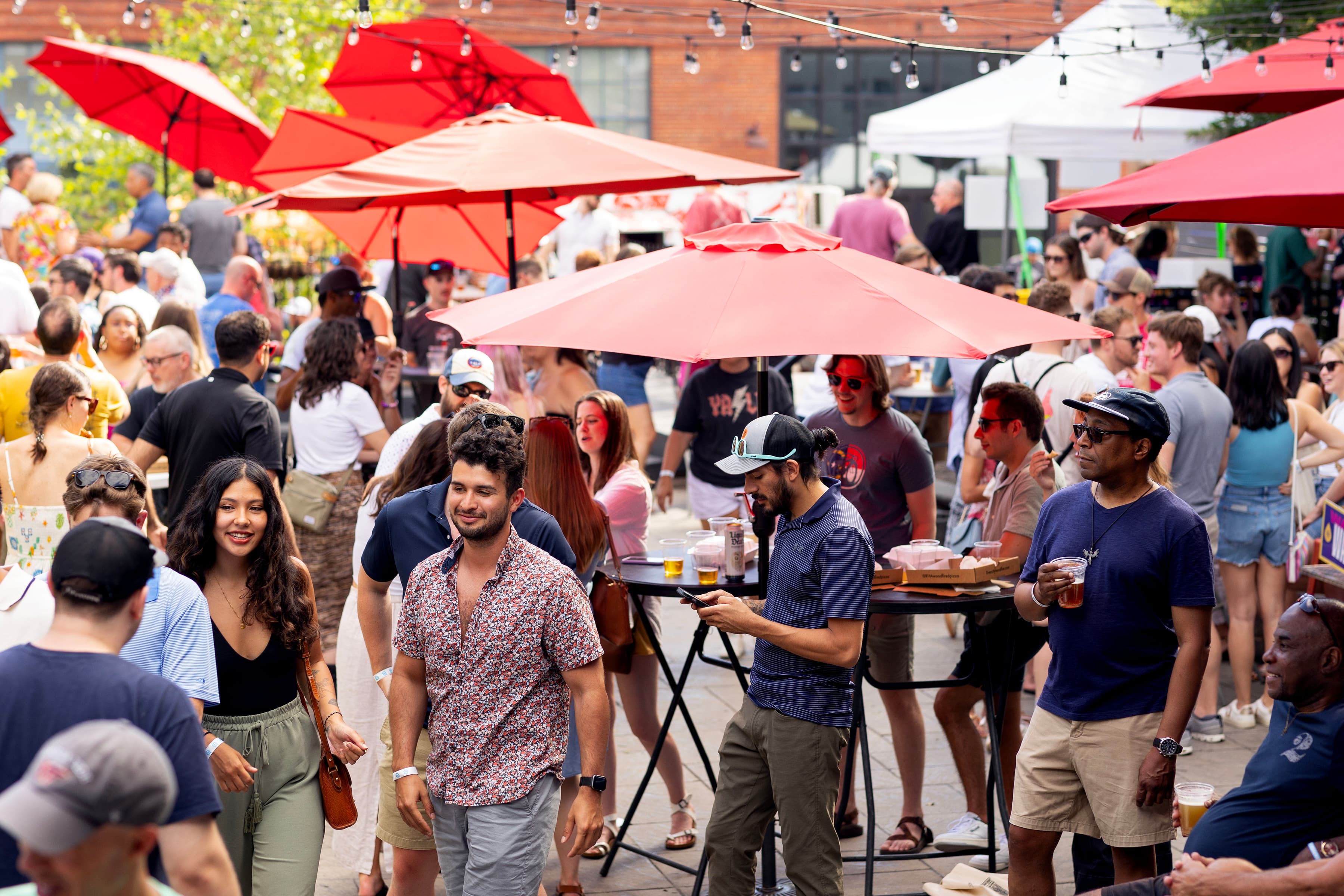 Outdoor patio filled with guests on a sunny spring afternoon